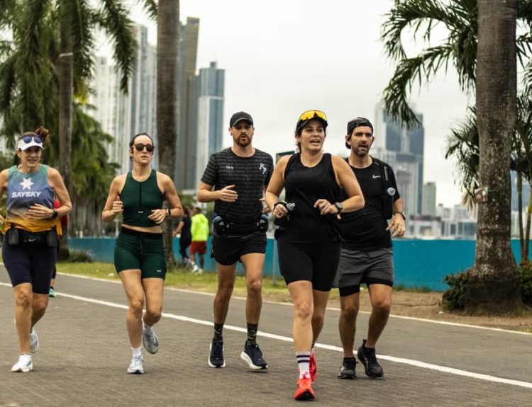 A group of diverse runners jogging along a scenic city pathway in Panama City, promoting healthy lifestyle.